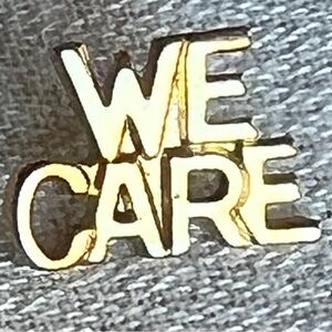 "WE CARE" vintage gold-tone lapel hat pin